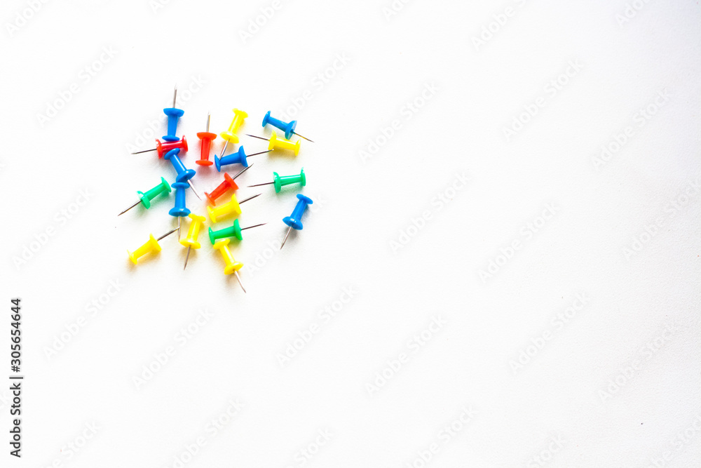 Red, blue, yellow and green stationery carnations on a white background, copy space Red, blue, yellow and green stationery carnations on a white background, copy space