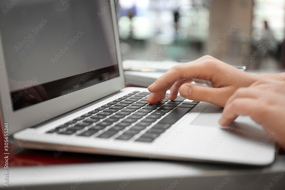 Blogger working with laptop in cafe, closeup Blogger working with laptop in cafe, closeup