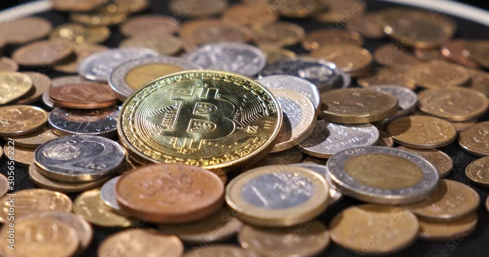 Lot small iron money is scattered on black fabric, camera rotates clockwise, in center is coin with symbol of bitcoin, coins of different countries, change, coin of future, cryptoeconomics, blockchain Lot small iron money is scattered on black fabric, camera rotates clockwise, in center is coin with symbol of bitcoin, coins of different countries, change, coin of future, cryptoeconomics, blockchain