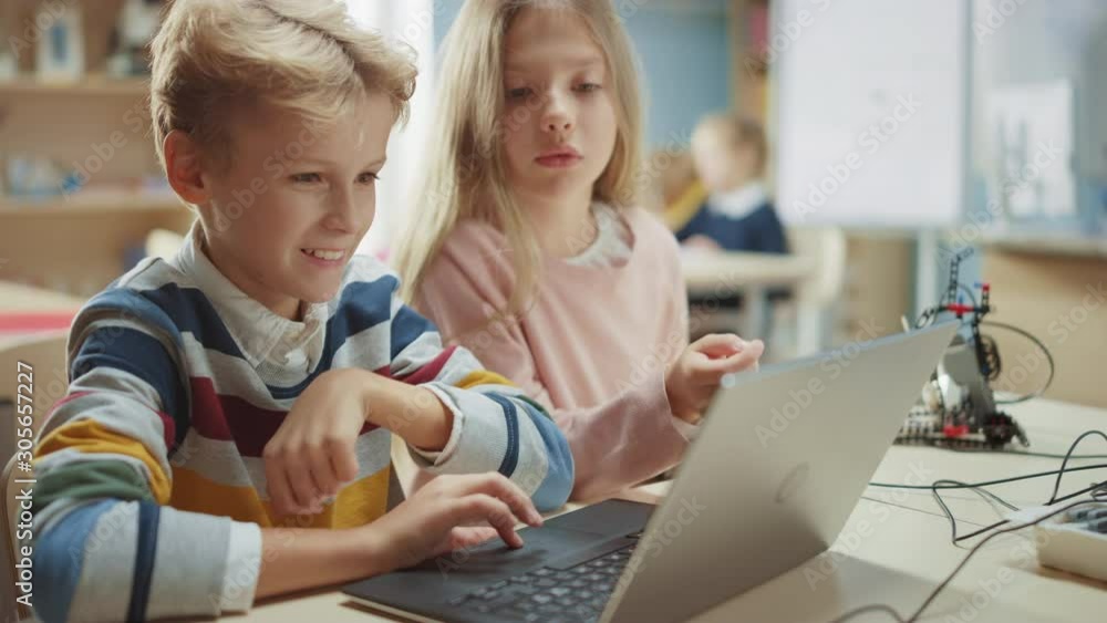 Brilliant Schoolgirl and Schoolboy Talk and Use Laptop to Program ...