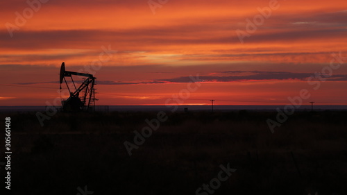 dusk in an oil well with machine working