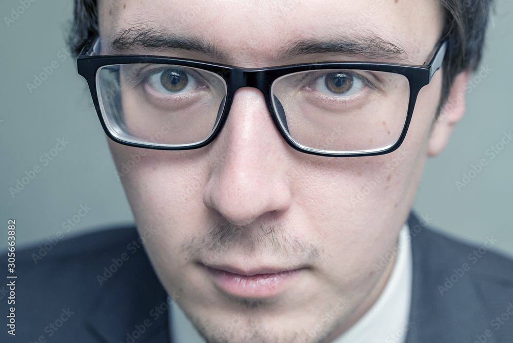 man's face in glasses close-up. a serious a man strictly looks. tyrant. unshaven, unkempt man in glasses close-up man's face in glasses close-up. a serious a man strictly looks. tyrant. unshaven, unkempt man in glasses close-up