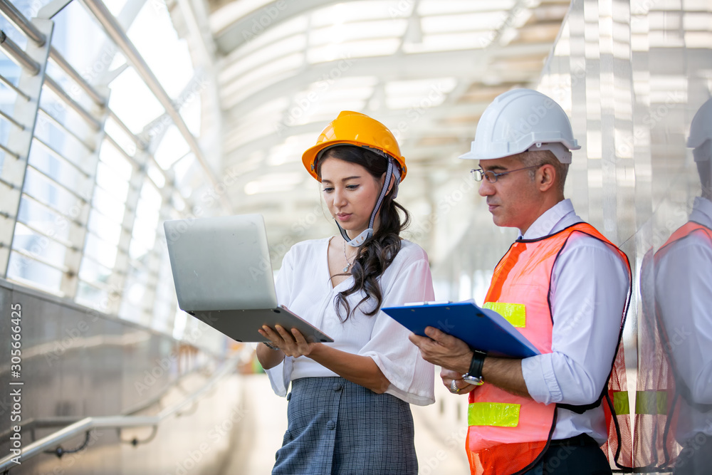 The engineer and business people hand high five against building. The concept of engineering, construction, city life and future. The engineer and business people hand high five against building. The concept of engineering, construction, city life and future.