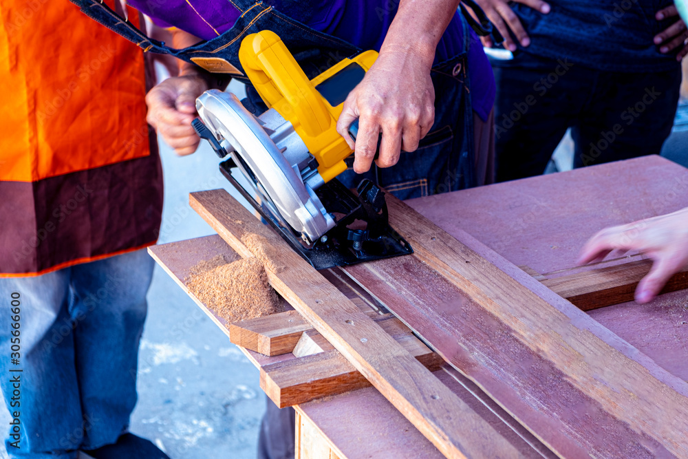 Blurred for background.Cutting wood hand power saw. Blurred for background.Cutting wood hand power saw.
