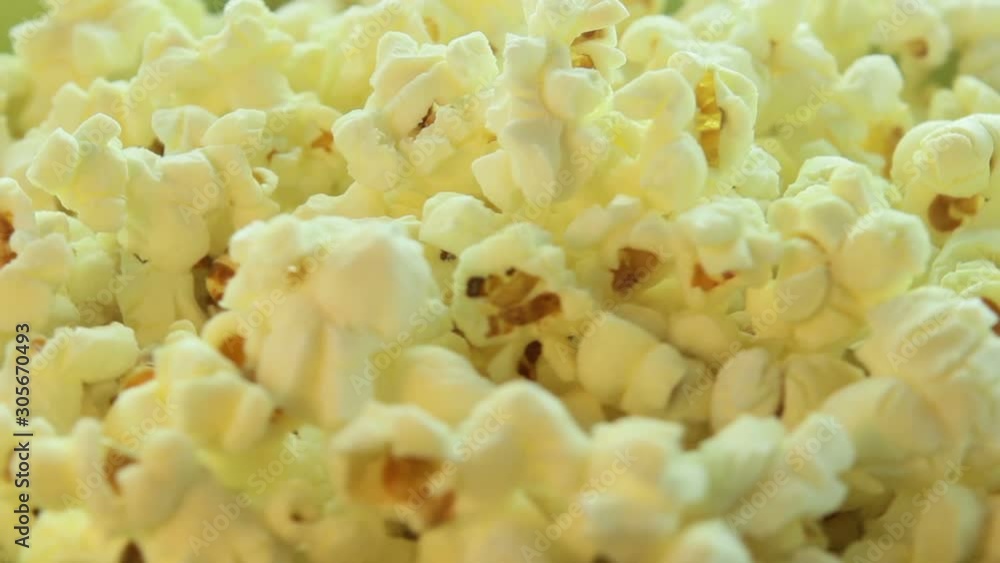 Salted popcorn rotating. Isolated on white background. Seamless loop. Closeup macro Salted popcorn rotating. Isolated on white background. Seamless loop. Closeup macro
