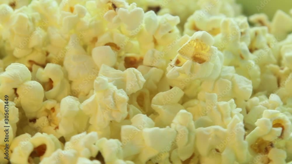 Salted popcorn rotating. Isolated on white background. Seamless loop. Closeup macro Salted popcorn rotating. Isolated on white background. Seamless loop. Closeup macro