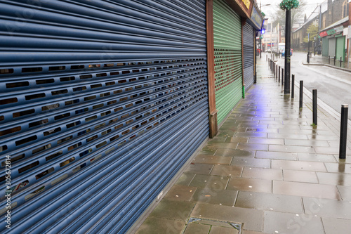 High Street Shops closing down with shutters closed, decline in shopping in Wales, United Kingdom