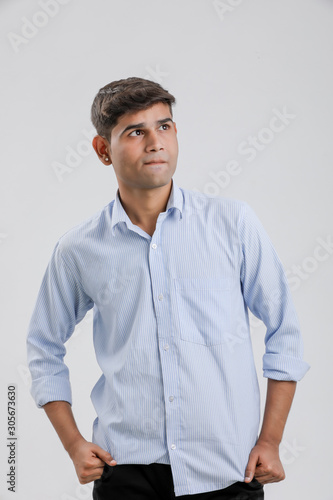 young indian man Standing over white background © Niks Ads