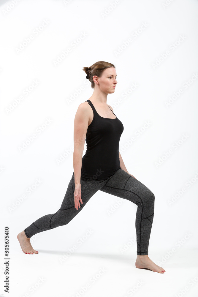 woman in gym clothes is doing some streching exercises woman in gym clothes is doing some streching exercises