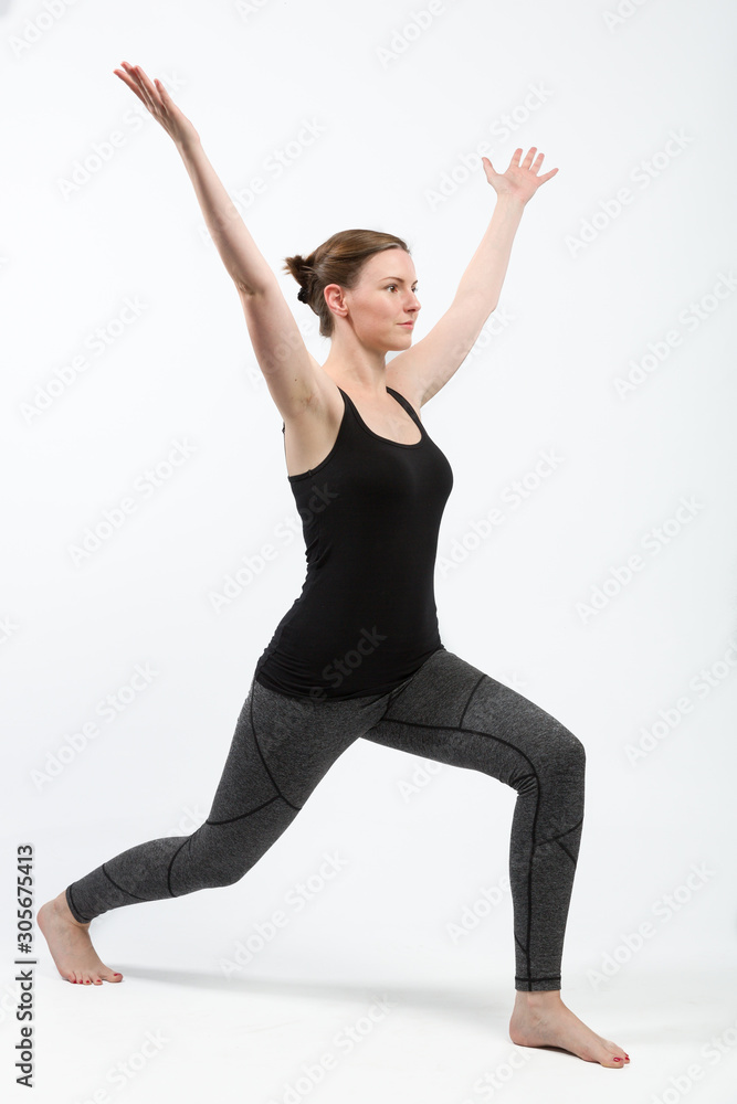 woman in gym clothes is doing some streching exercises