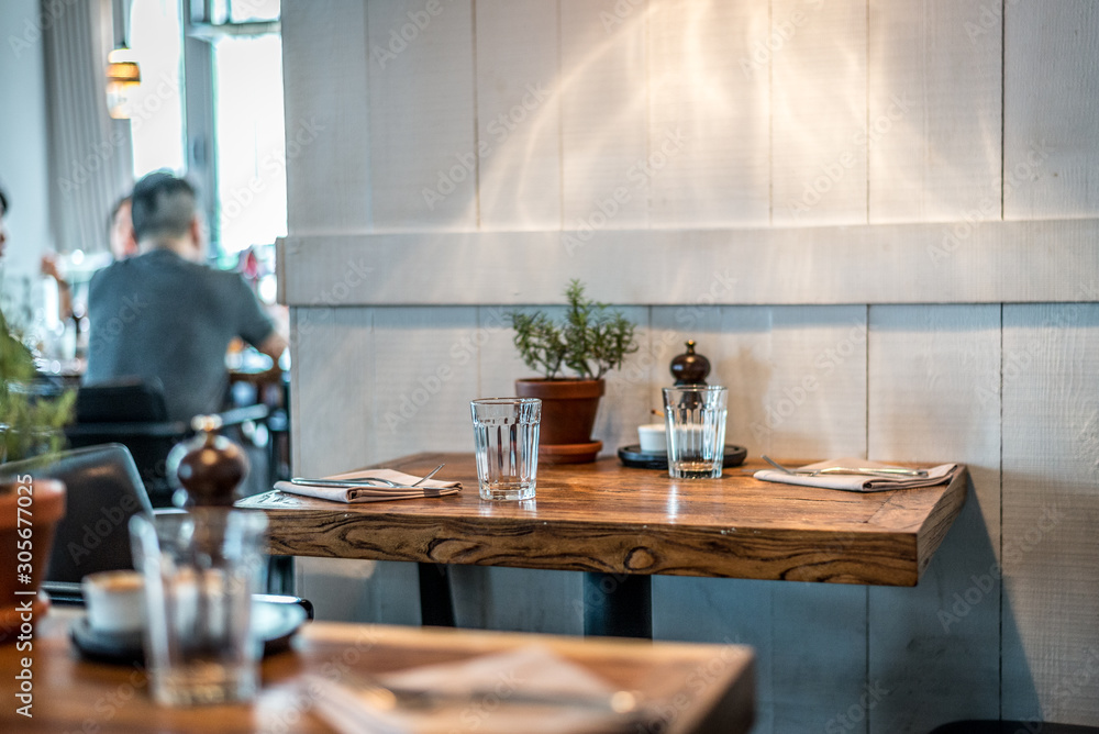 Fototapeta premium rustic country style restaurant with white walls, table seating and lamps