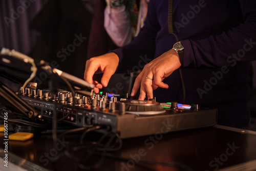 close up photo of a DJ mixing in the dark
