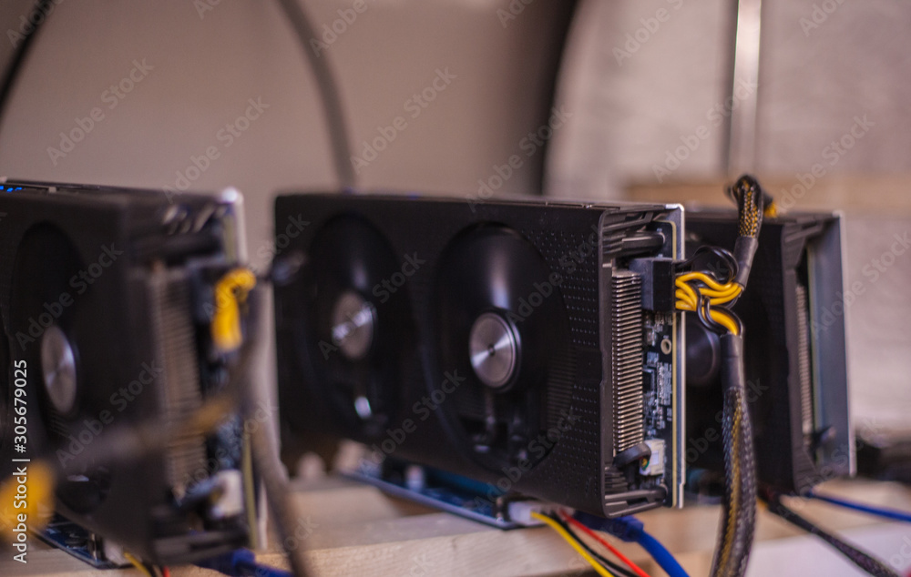 Video cards with on shelves connected to a farm for obtaining electronic money. Close-up. Out of focus. Blur Video cards with on shelves connected to a farm for obtaining electronic money. Close-up. Out of focus. Blur