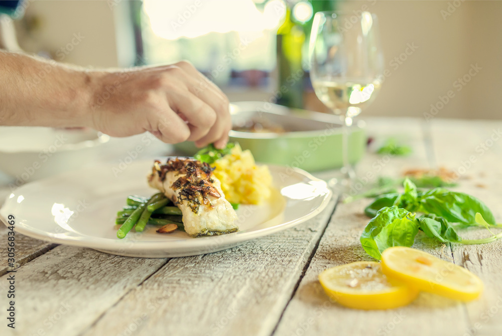 The cook has prepared the dishes and decorates it. The cook has prepared the dishes and decorates it.