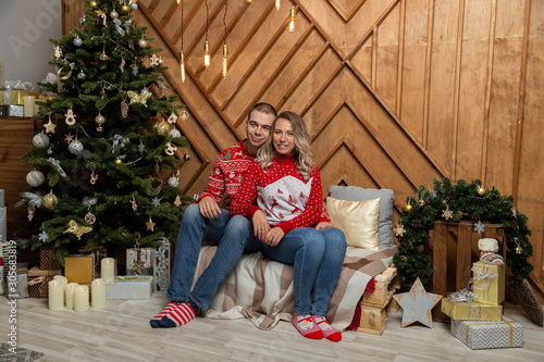 Beautiful happy couple in love in the Christmas decor for Christmas night. Happy Merry Christmas 2020. © combo1982