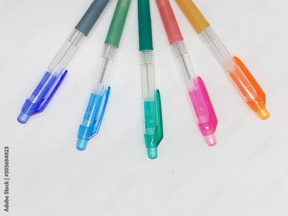 Hand Holding Colorful Artistic Pens for Coloring and Drawing Tools in White Isolated Background
