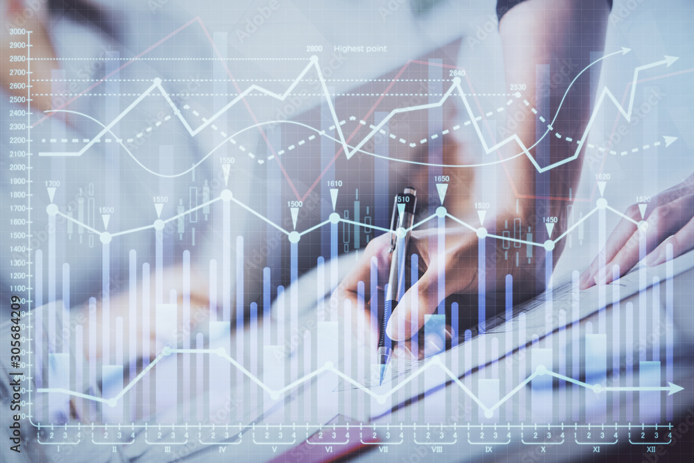 A woman hands writing information about stock market in notepad. Forex chart holograms in front. Concept of research. Double exposure A woman hands writing information about stock market in notepad. Forex chart holograms in front. Concept of research. Double exposure