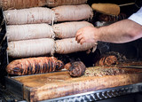 Meat rolls on skewer - kokoretsi (kokorech) roasting on the open fire on Istanbul street, Turkey. Tradition of national turkish cuisine - cooking the street food with a meat and vegetables in bread.