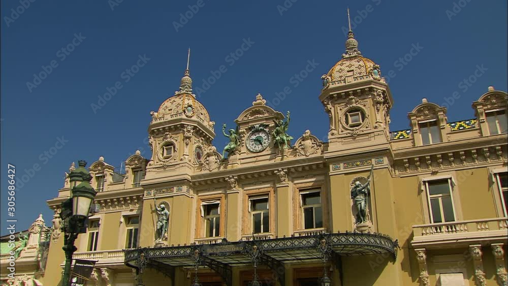 Close-up low-angle still shot of decorated grand Monte Carlo Casino building against a clear blue sky, Monaco, France Close-up low-angle still shot of decorated grand Monte Carlo Casino building against a clear blue sky, Monaco, France