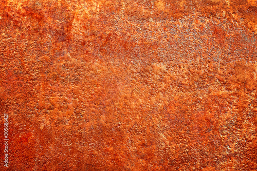 Closeup of a bright fiery red orange sheet of an old abandoned rusty metal.  ...