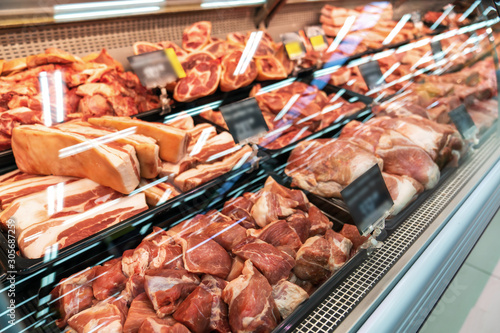 Selection of quality meat at a butcher shop, beef and pork, ham.
