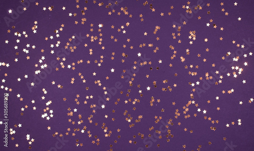 little gold stars on purple background Festive holiday background. Celebration concept. Top view, © shumytskaya