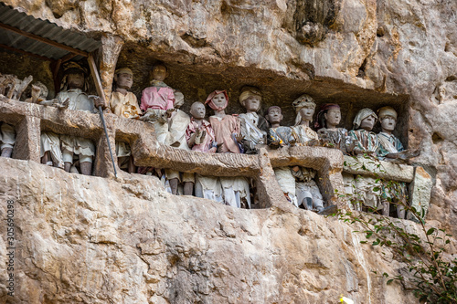 Tau tau, wooden statues representing dead men at burial cave, Tana Toraja, South Sulawesi, Indonesia