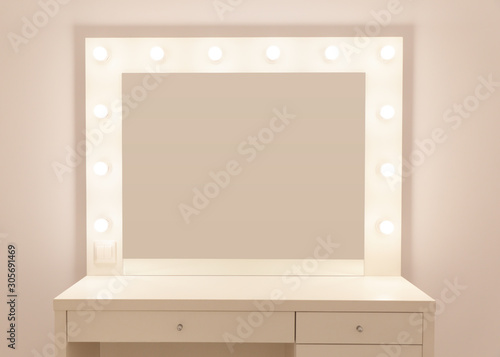Makeup mirror with gold lights. Photo of the mirror in the make-up room. Backstage dressing room