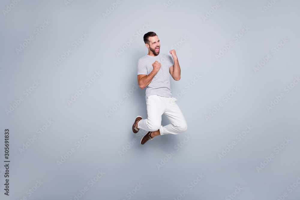 Full length body size view of his he nice attractive fit muscular sportive cheerful cheery glad bearded guy jumping rejoicing having fun isolated over light grey pastel color background Full length body size view of his he nice attractive fit muscular sportive cheerful cheery glad bearded guy jumping rejoicing having fun isolated over light grey pastel color background