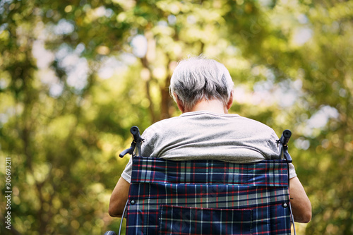 rear view of asian old man sitting wheel chair photo