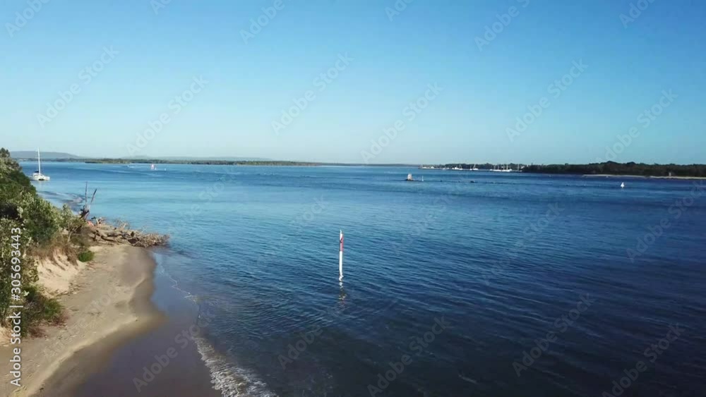 Drone Panning Above A Coastal Beach With White Sandy Shore At Sunrise Drone Panning Above A Coastal Beach With White Sandy Shore At Sunrise