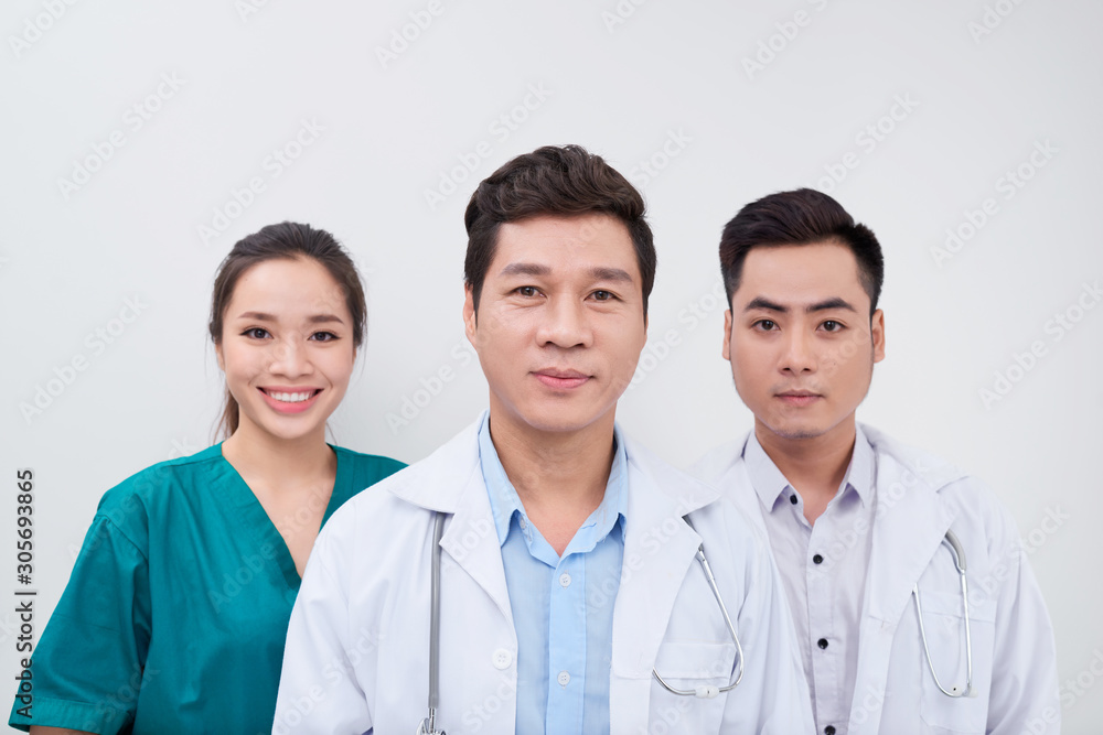 Group of Asian medical workers/ doctors and nurse smiling at camera Group of Asian medical workers/ doctors and nurse smiling at camera
