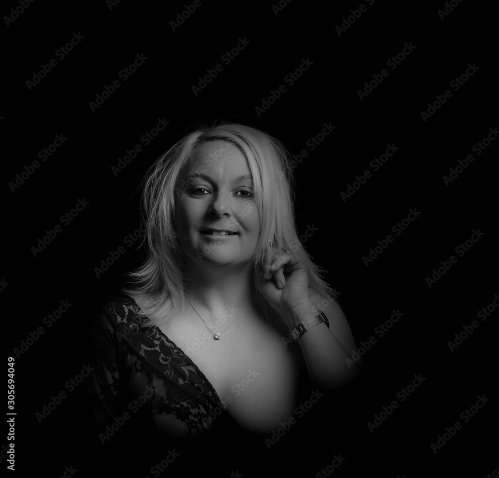 Black and white portrait of a lady undressing from her lace see through top Black and white portrait of a lady undressing from her lace see through top