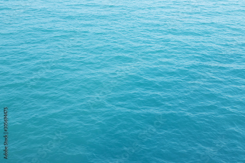 Blue Sea surface aerial view with waves from a drone, empty blank to background. soft focus. © methaphum
