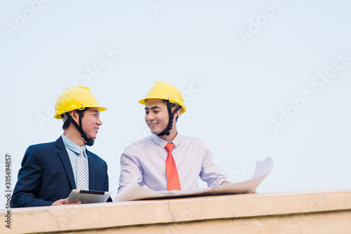 Asian engineer was acting with his secretary on the Business building background.