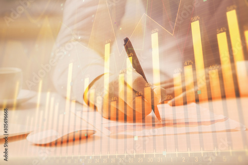 Financial trading chart multi exposure with man desktop background. © peshkova