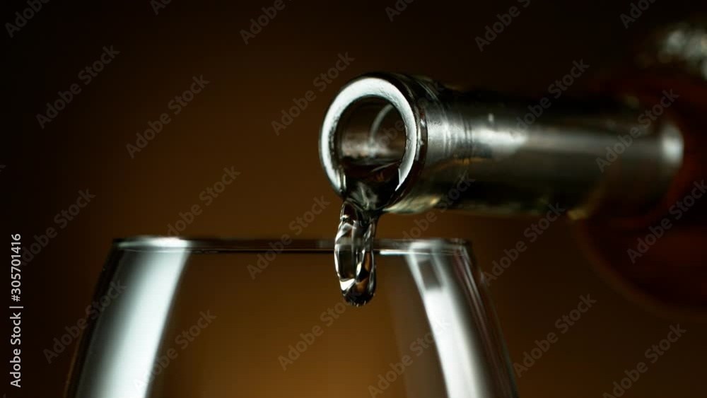 Super slow motion of pouring white wine into glass in detail. Filmed on high speed cinema camera, 1000 fps Super slow motion of pouring white wine into glass in detail. Filmed on high speed cinema camera, 1000 fps