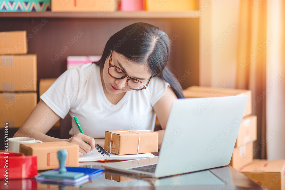 Startup small business owner working at house. Young asian woman happy with the sale of goods online. Student who work with careers supplemented by online sales via social media. Startup small business owner working at house. Young asian woman happy with the sale of goods online. Student who work with careers supplemented by online sales via social media.