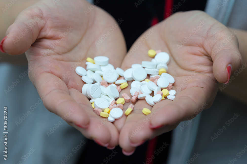 girl wants to drink a lot of pills on a white background girl wants to drink a lot of pills on a white background