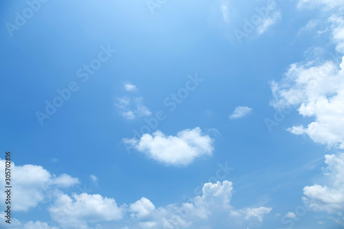 Beautiful clear blue sky background with tiny plain white cloud on morning time rays sunlight. space for text. soft focus.