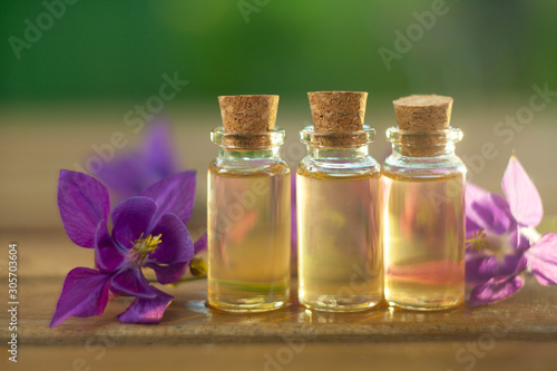 Essence of flowers on table in beautiful glass jar