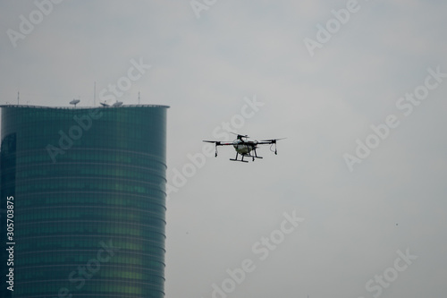 Industrial Drone Flying in town with building in background photo