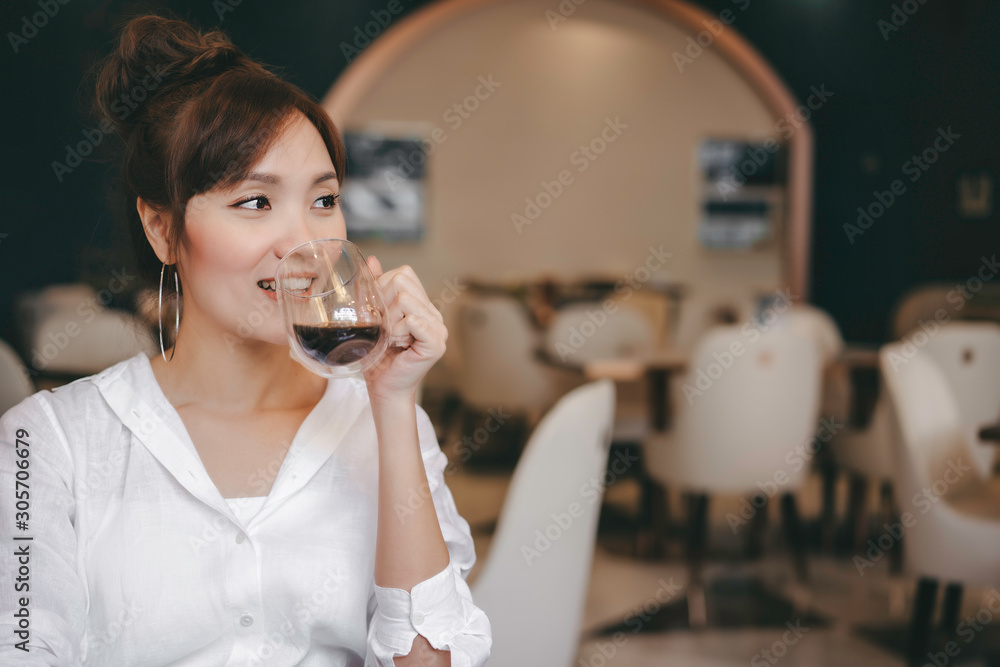 Young cheerful woman drinking hot coffe at coffee shop and restaurant in morning time with breakfast meal. Feeling happiness and relax with smiling face before going to wok Young cheerful woman drinking hot coffe at coffee shop and restaurant in morning time with breakfast meal. Feeling happiness and relax with smiling face before going to wok