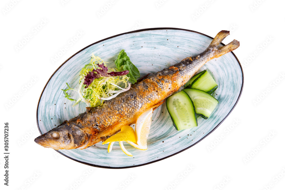 Fish fried on coal with lettuce leaves and cucumbers Fish fried on coal with lettuce leaves and cucumbers