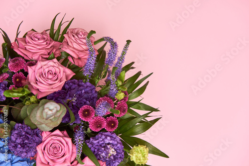 Beautiful bouquet of pink  purple and blue flowers on pastel pink background  copy space. Greeting card for Womens Day  Mothers Day  Valentines Day  wedding  birthday. Top view  flat lay