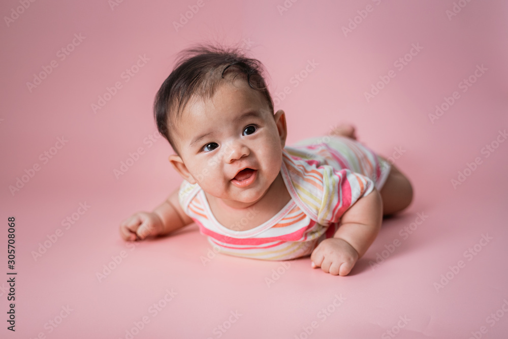 baby laying on her belly. tummy time cute baby in studio portrait baby laying on her belly. tummy time cute baby in studio portrait