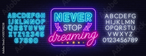 Never stop dreaming neon lettering. Neon alphabet on a dark background. Template for design.