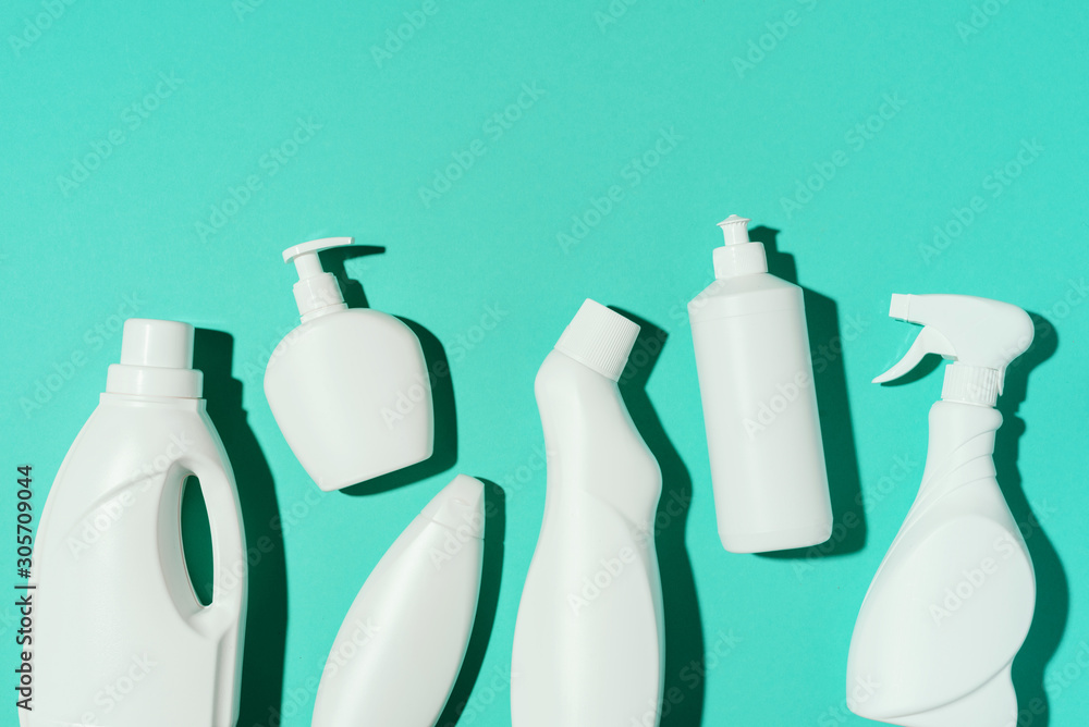 Pattern of white plastic bottles, containers of chemical cleaning products on blue background. Top view. Flat lay. Stop plastic, recycling, separate collection of garbage concept Pattern of white plastic bottles, containers of chemical cleaning products on blue background. Top view. Flat lay. Stop plastic, recycling, separate collection of garbage concept