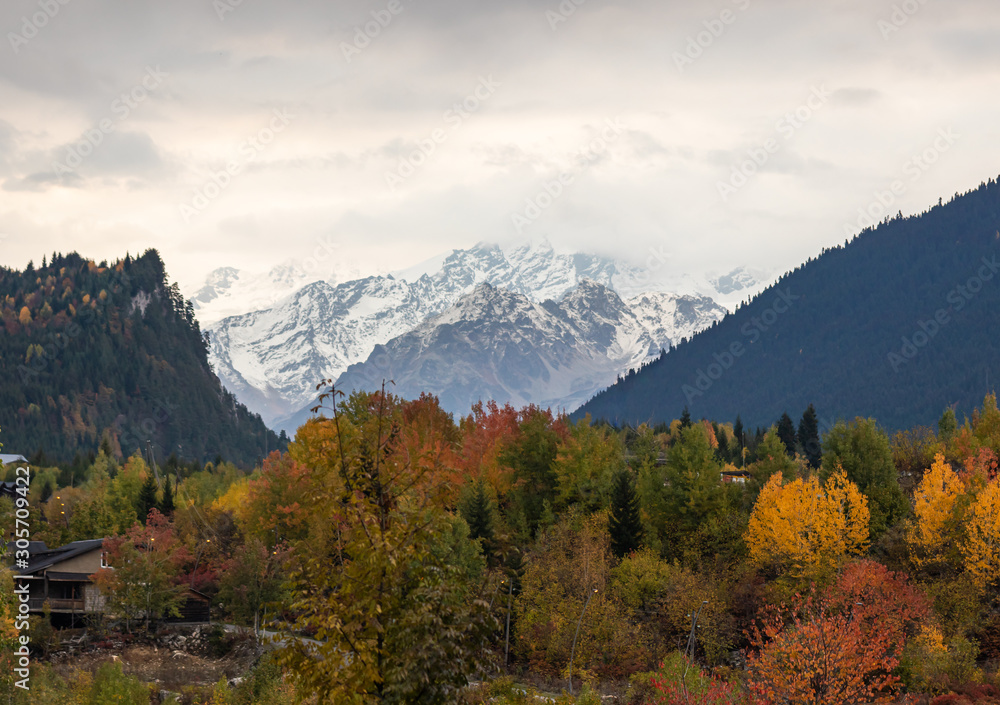 Panoramic  view in the early morning of snow-capped peaks of mountains with low clouds in Svaneti, in the mountainous part of Georgia