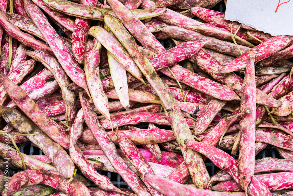 Pink red sugar peas displayed on the vegetable market stall. Pink red sugar peas displayed on the vegetable market stall.